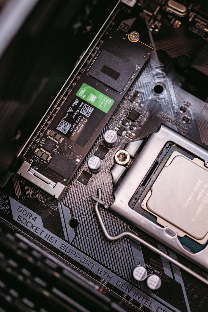 Detailed view of a computer motherboard with a CPU and an installed SSD, highlighting modern technology components.